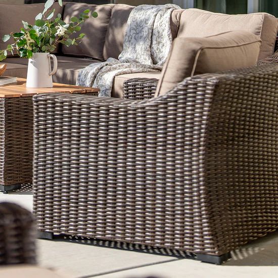 Side view of outdoor wicker chair by sofa from Villa Outdoors